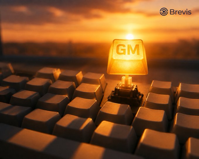 A close-up photo of a glowing computer keyboard key displaying 'GM' set against a golden sunset background, with the 'Brevis' logo in the corner.