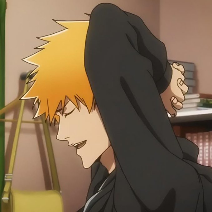An anime still showing a character with spiky orange hair stretching his arms behind his head with a slight smile.