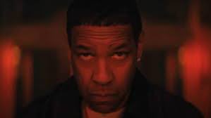 A close-up shot of a man's face illuminated by warm orange lighting, his expression intense and unamused. The caption "still doing this i see" suggests the image captures a moment of skeptical observation, implying the man is watching someone's questionable or repetitive behavior with disapproval.