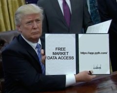 The image shows a man sitting at a desk with a sign that says "Free Market Data Access" written on top of his lapel, indicating that he has access to market data for free. The background reveals another person wearing a suit and tie, suggesting they are in a professional setting such as an office or a meeting room.