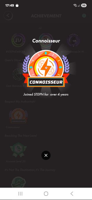 The image shows an achievement screen for a mobile device, displaying a badge that reads "CONNOISER". The screen also features a list of achievements, including joining a stepn4 for over four years. The text "JOINED STEPS FOR OVER 4 YEARS" is displayed on the screen, indicating that the user has achieved this milestone.