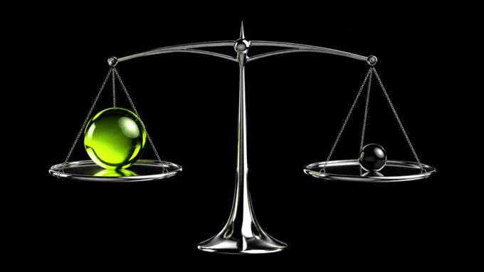 A digital illustration of a metallic balance scale with a glowing green sphere on the left pan and a small black sphere on the right pan against a black background.