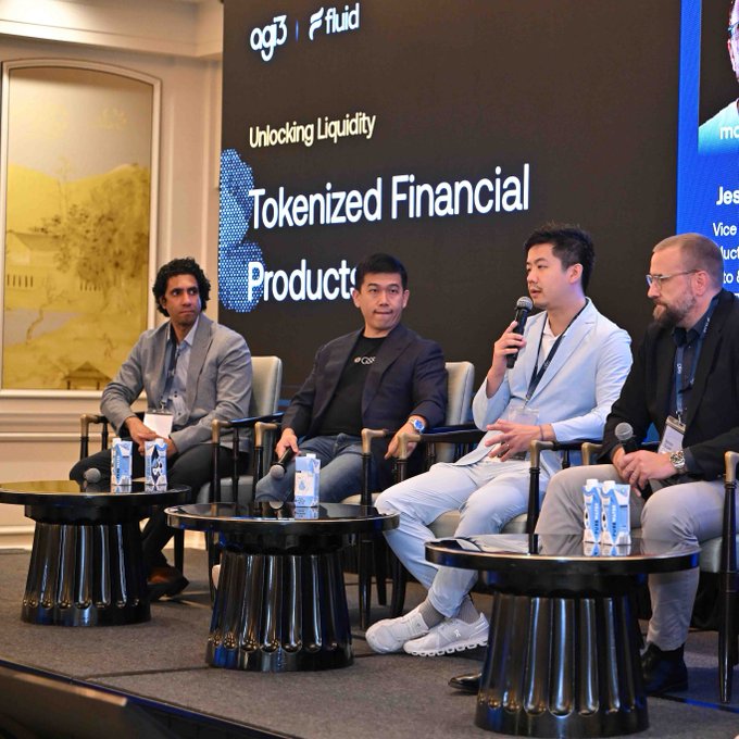 Four panelists sit on stage at a conference discussing 'Tokenized Financial Products' and 'Unlocking Liquidity,' with 'a13' and 'fluid' logos visible on the banner behind them.