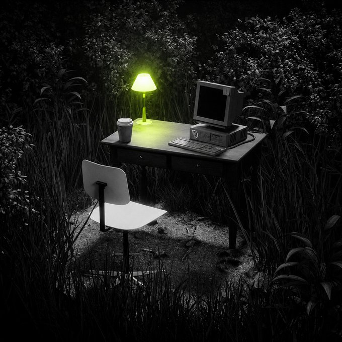 An office desk with a computer, lamp, and coffee cup is set up in a dark, grassy outdoor area, contrasting the "touch grass" advice with the "touch charts" reality of indoor work.