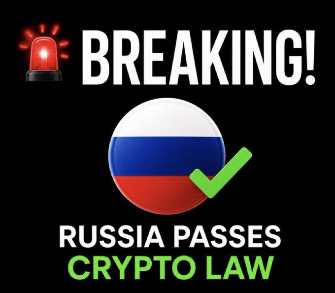 A breaking news graphic featuring a red alarm light, a Russian flag with a green checkmark, and the text 'RUSSIA PASSES CRYPTO LAW'.