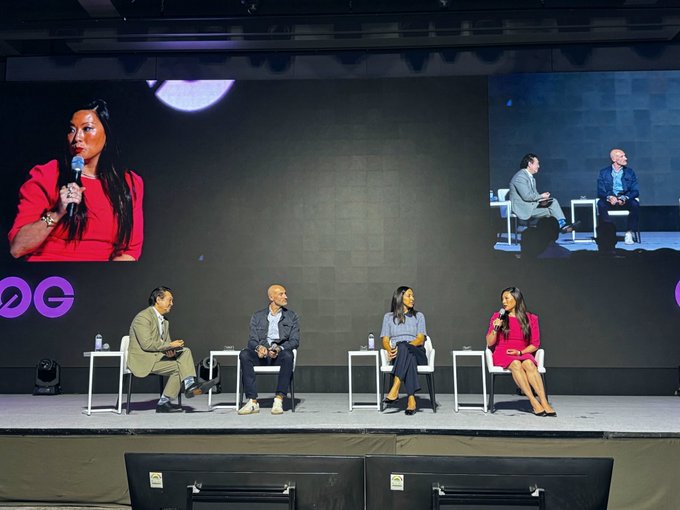 A panel of four speakers sits on stage at what appears to be a Money 2020 conference, with a large screen displaying the woman in red speaking into a microphone alongside two men in suits. The setup reflects the post's discussion of tokenization and market access, likely featuring representatives from Ripple, Figure, and Keybanc, as indicated by the tagged organizations.
