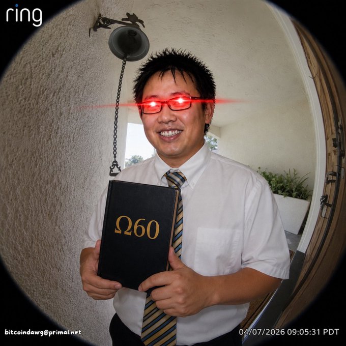 A man in a shirt and tie stands at a door holding a black book labeled "Ω60" (Omega 60) in gold lettering, captured from a Ring doorbell camera that has humorously added glowing red laser eyes to him, playing on the post's reference to "Omega60" arriving at the door. The timestamp reads 04/07/2026 09:05:31 PDT, with "bitcoindawg@primal.net" watermarked at the bottom.