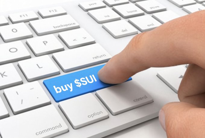 The image shows a close-up of a hand pressing a blue key on a white computer keyboard. The key is labeled 'buy $SUI', representing a command to purchase the cryptocurrency SUI.