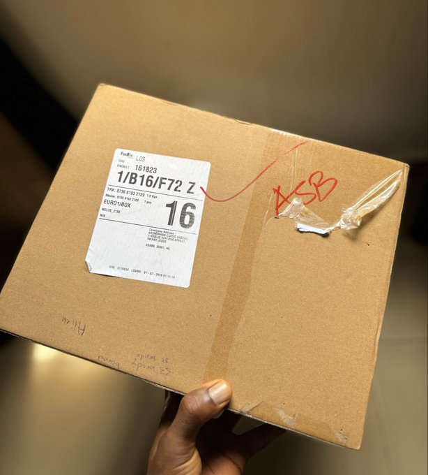 A hand holds a FedEx package labeled "1/B16/F72" and "EURO1/BOX" with "16" printed in large bold text, also marked "ASB" in red marker, likely containing the new WalletConnect merch referenced in the post.