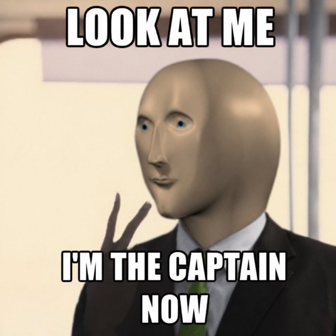 A popular meme featuring the Meme Man character (a beige humanoid face) wearing a suit and tie with the text "LOOK AT ME I'M THE CAPTAIN NOW".