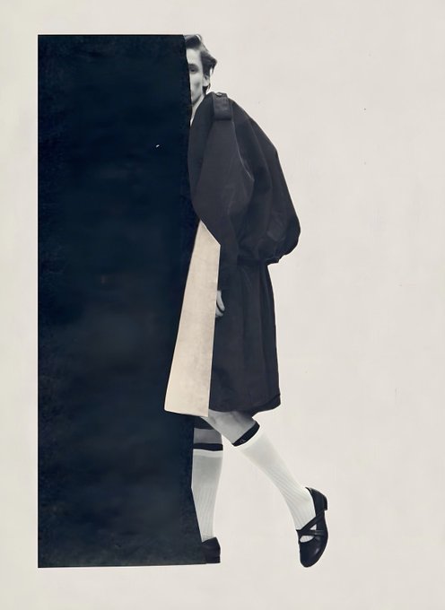 A black and white artistic photo or collage showing a person in a trench coat and knee-high socks with loafers, partially obscured by a black vertical panel.