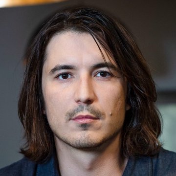 A man with long dark hair and a soul patch gazes contemplatively off-camera, his thoughtful expression mirroring the poised optimism behind the post's claim that DeFi total value locked is quietly expanding across emerging blockchains beyond the spotlight of mainstream coverage.