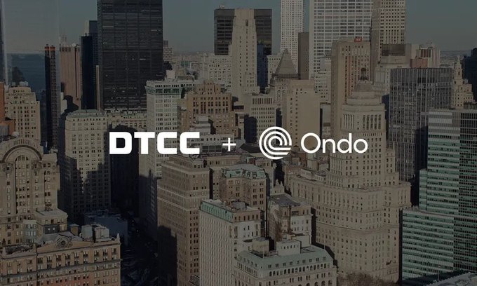 A dark aerial view of a dense city skyline, likely a financial district, is overlaid with the text "DTCC + Ondo" in white lettering.

The image's financial district backdrop and "DTCC + Ondo" branding visually represent the collaboration between major traditional finance infrastructure and crypto, as described in the accompanying post about launching tokenized U.S. stocks.