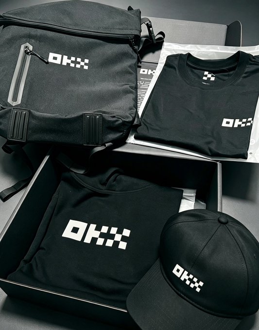 A collection of black merchandise including a backpack, t-shirt, sweatshirt, and cap, all featuring the white 'OKX' logo.