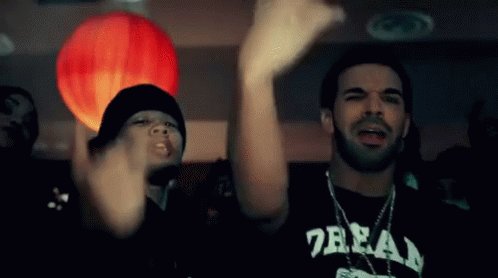 The image features a man wearing a black shirt with white text that says "7ZEA". He is standing next to another person who is also dressed in black, both of them raising their hands in the air as if they are cheering or celebrating something. The background of the image shows a red balloon and a lamp, adding to the festive atmosphere. The caption for the image reads: "Introducing MGUSD. MoneyGram's native U.S. dollar stablecoin. Natively issued on @StellarOrg. Built with @Stablecoin, @M0 and @FireblocksHQ."