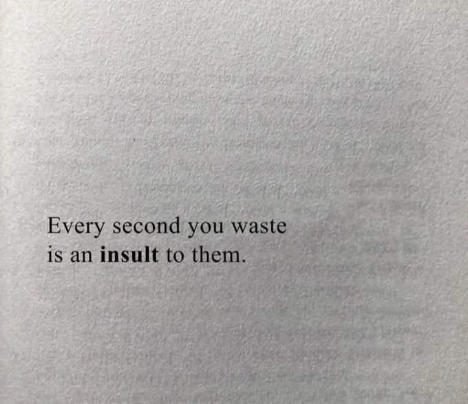 A printed page displays the text: 'Every second you waste is an insult to them.'