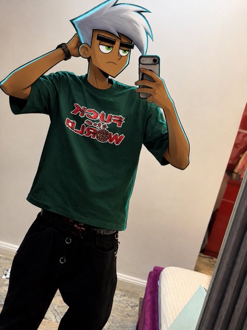 A cartoon-style edited photo of a young man taking a mirror selfie while wearing a green 'FUCK MARRY KILL' t-shirt and black pants.