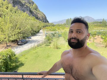 A shirtless bearded man takes a selfie on a balcony overlooking a scenic valley with mountains and a parked car below, playfully committing to posting daily selfies until the $HYPE token reaches three digits. The relaxed outdoor setting reflects the casual, meme-like spirit of his social media pledge.
