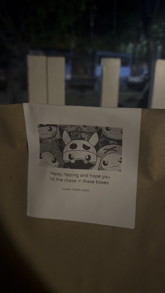A note on a cardboard box reads 'happy ripping and hope you hit the chase in these boxes: swam, fresh water' below a pixel art image of three Pokémon characters.