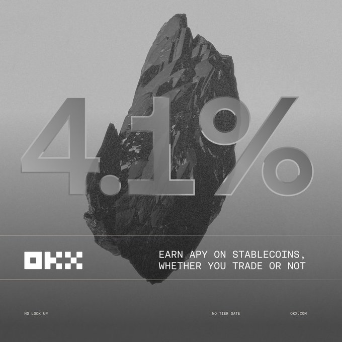 The image is a grayscale OKX promotional ad featuring a rugged dark crystal or rock formation, with "4.1%" displayed prominently in large translucent text, and the tagline "EARN APY ON STABLECOINS, WHETHER YOU TRADE OR NOT," along with "NO LOCK UP," "NO TIER GATE," and "OKX.COM."

This visual reinforces the post's message by highlighting OKX's 4.1% APY yield offering for eligible US VIPs on USDG, emphasizing the no-lock-up and no-tier-gate benefits that make premium yield accessible without traditional paywall restrictions.