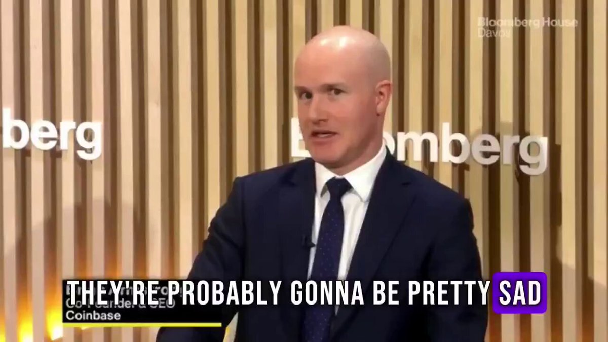 The focus of this image is a man wearing a suit and tie standing at a podium, which appears to be against a board wall with the words "BERG" and "COINBASE" visible behind him. He seems to be speaking or presenting something related to Bitcoin, as indicated by the quote provided in the image, which suggests that there might be a connection between Bitcoin and sadness for those without it. The presence of the Bitcoin text indicates an attempt at humor or satire, possibly implying that becoming poor due to not owning Bitcoin would make someone sad.