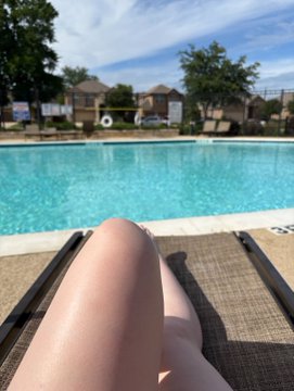 A person relaxes by a sunny community pool, lounging with their legs stretched out on a deck chair. The image reflects the post's playful theme of "lying flat and playing dead" on a Saturday, perfectly matching the laid-back weekend vibe away from trading.