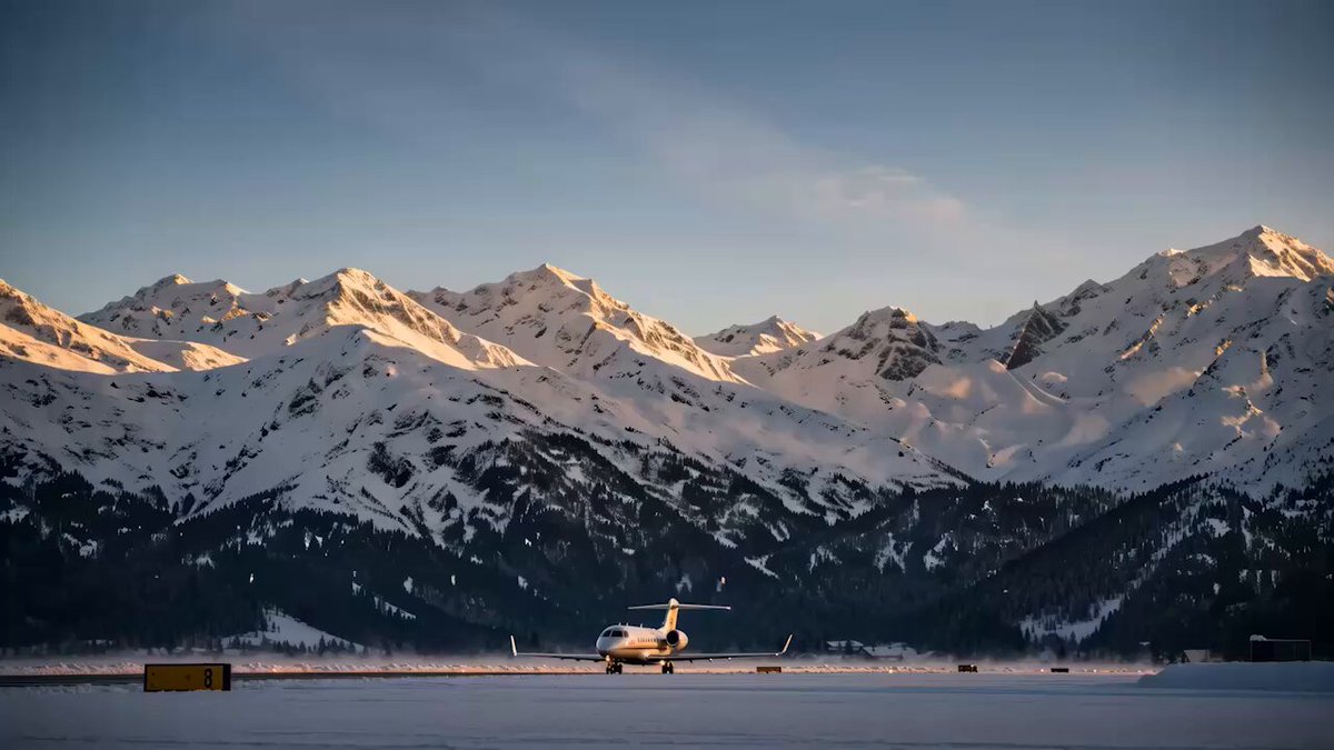 The image shows an airport runway with a small airplane parked at the end of it. The scene also includes snow-covered mountains in the background, suggesting that the photo was taken during winter or near a mountainous region. The text in the caption reads "Before takeoff, there is a runway. A phase where infrastructure is tested, capital begins to move, users start earning and the market gains clarity on what is being built." This implies that the airport is preparing for takeoff, possibly with ongoing construction work or maintenance activities taking place at the runway. The presence of snow in the mountains indicates that the area experiences cold temperatures during this time of year.
