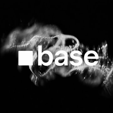 The image features the "base" logo in white text with its signature square symbol, set against a black background with abstract, smoky white visuals. It visually represents the Base blockchain network being referenced in the announcement about Coinbase Tokenized Stocks (B20 tokens) being live on Base.