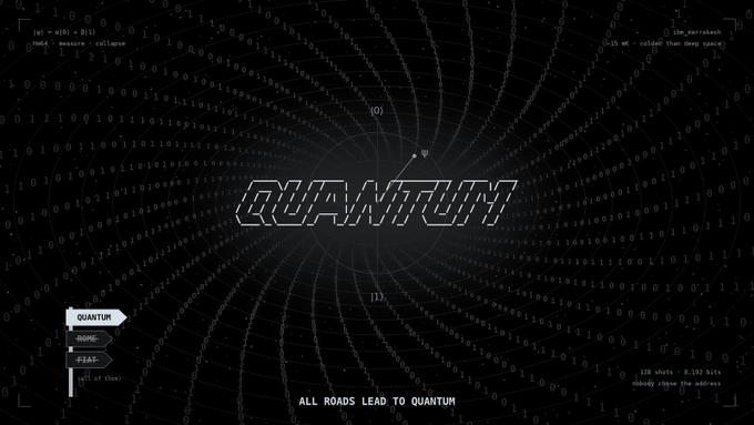 A digital/tech-themed wallpaper featuring the word 'QUANTUM' in a stylized font over a dark background filled with binary code patterns radiating from the center, with the tagline 'ALL ROADS LEAD TO QUANTUM'.
