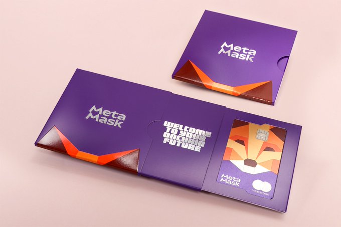 Purple MetaMask-branded packaging with an open envelope revealing a card and the text 'WELCOME TO YOUR ONCHAIN FUTURE.'