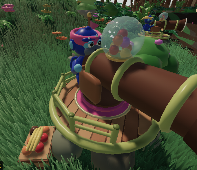 A 3D rendered scene from a game features a blue character standing on a circular platform next to a brown cannon-like structure with green rings, set in a grassy environment with mushrooms and a treasure chest nearby.