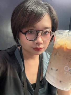The image features a woman wearing glasses holding a large cup of coffee or tea with ice cubes inside. The caption reads "GM Did you see my new drop on my pin? If you didn't, i picked it right here HING+ECHO on Manifold". This suggests that the woman is sharing her experience and appreciation for the drink she's enjoying while wearing glasses.
