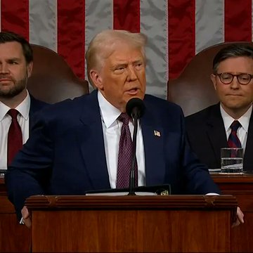 In the image, a man wearing glasses and a suit is standing at a podium delivering a speech with Trump seated behind him and another individual sitting next to him. The man appears to be giving a speech or addressing an audience within a courtroom setting. The caption of the image suggests that the speaker may have encountered difficulties in accessing funds from Ripple, but was determined to continue delivering his message by forcing Ripple to answer their application within 90 days.