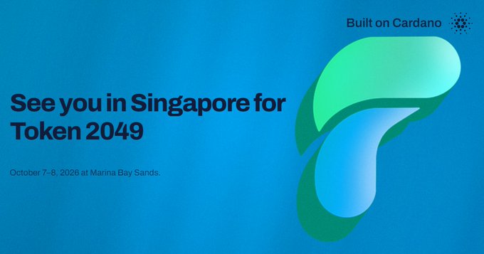 A blue promotional graphic for 'Token 2049' reads 'See you in Singapore for Token 2049' on 'October 7-8, 2026 at Marina Bay Sands', with 'Built on Cardano' text and logo in the top right.