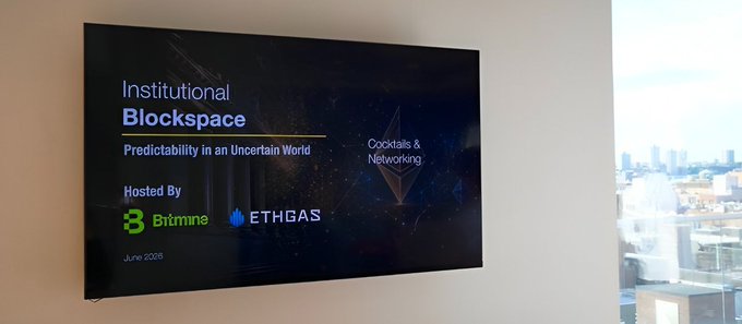 A wall-mounted display screen shows an event titled "Institutional Blockspace: Predictability in an Uncertain World," with a "Cocktails & Networking" segment, hosted by Bitmine and EthGas, dated June 2026. The image relates to the post by highlighting the EthGas and Bitmine co-hosted institutional event that the user discovered while reviewing project updates, noting they had missed it too late.