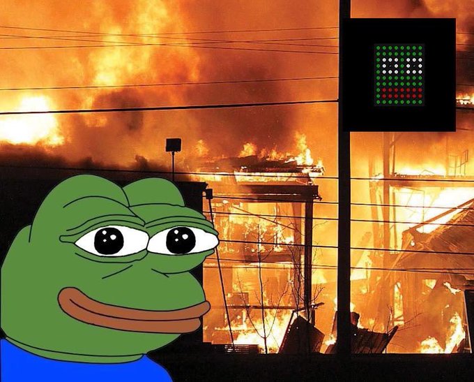 A Pepe the Frog meme superimposed over an image of a large fire engulfing buildings, with a digital display showing colored dots in the upper right.