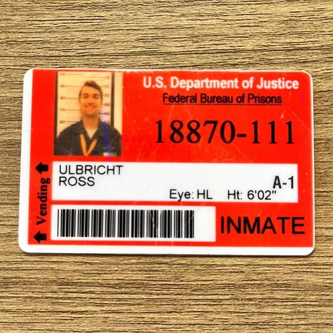 A U.S. Department of Justice Federal Bureau of Prisons inmate ID card for Ross Ulbricht, registration number 18870-111, marked 'INMATE' and 'Vending'.