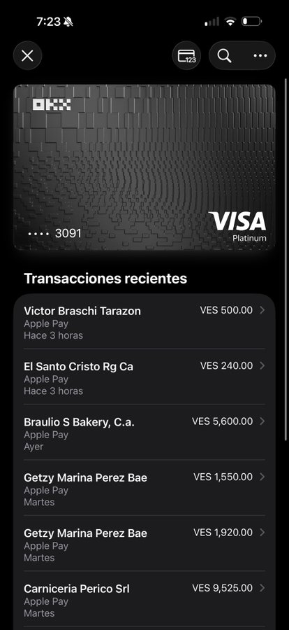 A screenshot of the OKX Visa Platinum card interface showing recent transactions, including charges at El Santo Cristo (VES 240), Braulio S Bakery (VES 5,600), and Carniceria Perico Srl (VES 9,525), supporting the claim that the card functions smoothly with no hidden fees.
