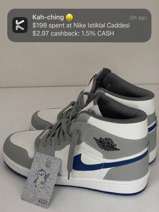 A photo of grey, white, and blue Nike Air Jordan sneakers with a price tag notification showing "$198 spent at Nike Istiklal Caddesi" and "$2.97 cashback: 1.5% CASH".