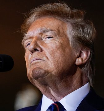 The image shows a close-up of Donald Trump, likely representing the US government's actions described in the accompanying post about sanctions against Iranian crypto exchanges and rewards for information.