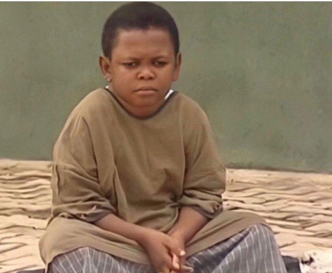 A young boy with a puzzled expression sits on a bed, wearing an oversized brown shirt and striped pants, mirroring the confusion of many in the crypto community trying to understand the distinction between Web3 and cryptocurrency.