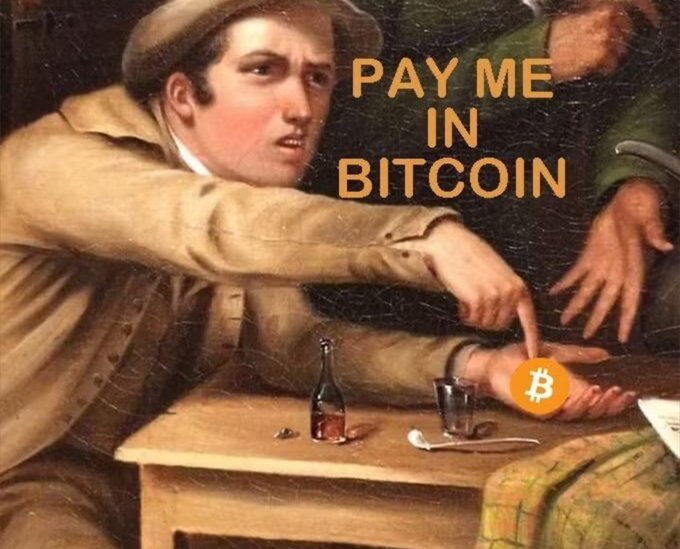 A man in a painting gestures emphatically at a Bitcoin coin overlaid on his hand, with bold orange text reading "PAY ME IN BITCOIN" and a bottle and spoon on the table, capturing the meme's sentiment that demanding crypto is an unavoidable reality in modern dealings.