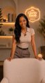 A small image of a woman in a vintage-style uniform standing behind a counter in a warmly lit cafe setting.