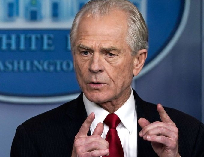 An older man with gray hair wearing a dark suit and red tie speaks at a podium with the White House logo visible in the background.
