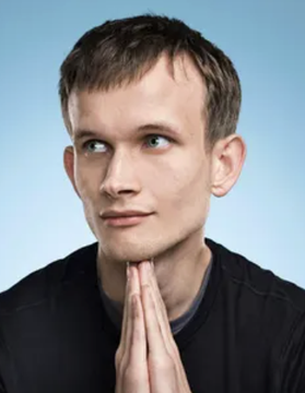 A man with short brown hair gazes thoughtfully upward with his hands clasped together in a contemplative gesture against a blue background, embodying the optimism of the post about Ethereum's validator exit queue dropping to zero—a bullish signal that no validators are currently waiting to unstake their ETH.