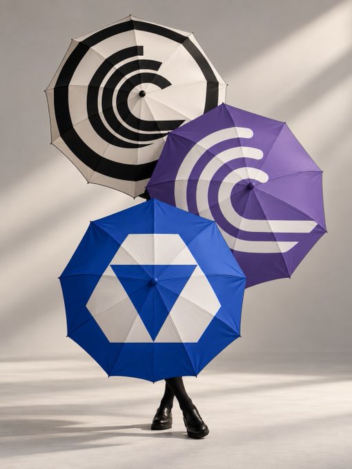 A creative photograph of three open umbrellas—one black and white with a 'C', one purple with a white 'C', and one blue with a white geometric logo—arranged to obscure a person's upper body, leaving only their black shoes visible against a plain background.