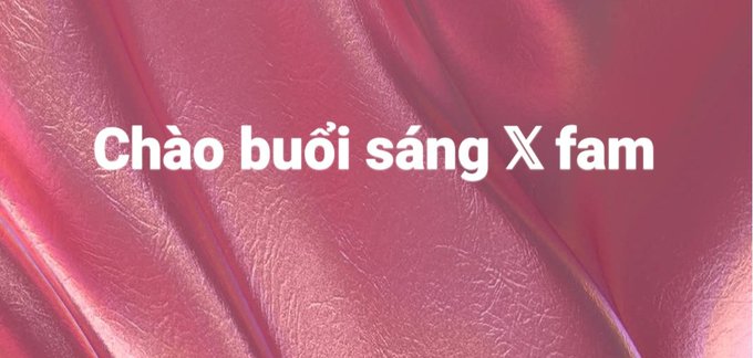 A pink satin or silk textured background with white text reading "Chào buổi sáng X fam" (Good morning X fam in Vietnamese).