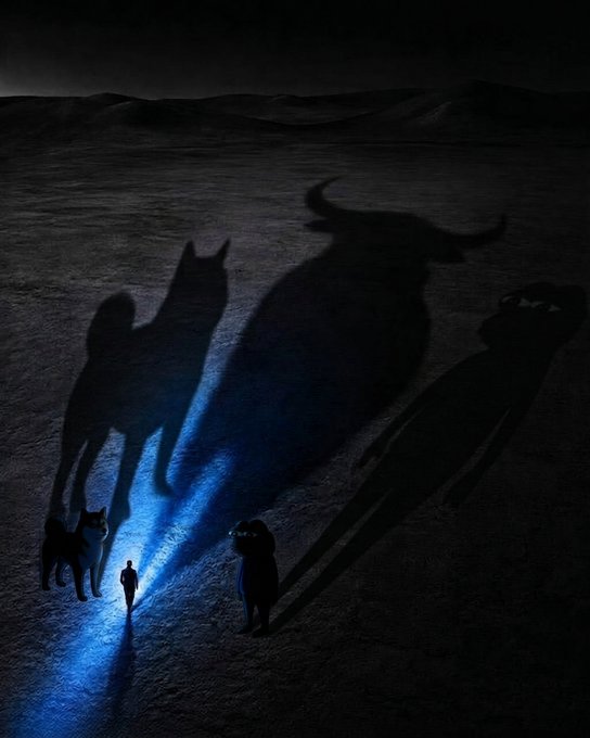 A dark, dramatic image showing a small person walking with dogs, casting massive, ominous shadows that resemble a wolf, a bull, and a strange humanoid creature on the ground.