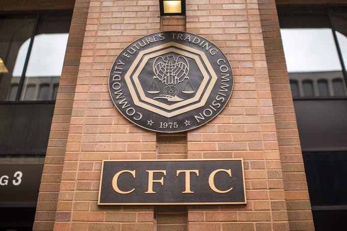 The image shows the exterior of a brick building featuring the official seal of the U.S. Commodity Futures Trading Commission (CFTC), established in 1975, along with a plaque displaying "CFTC" and the partial address "G 3," likely indicating the agency's Washington, D.C. headquarters. This visual directly supports the accompanying post about the CFTC's bullish stance on crypto regulation, illustrating the very institution that has declared its readiness to issue crypto rules independently of the Senate's failure to pass the CLARITY Act.