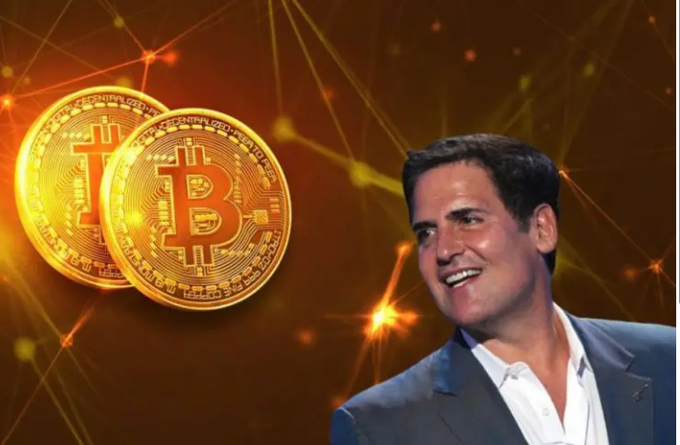 Mark Cuban smiling beside two golden Bitcoin coins against an orange digital network background.